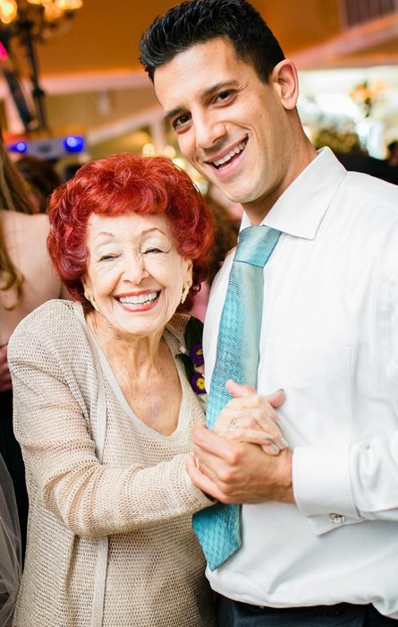 Joyful moment as a man dances with his elderly granny, highlighting the warmth of intergenerational connections.